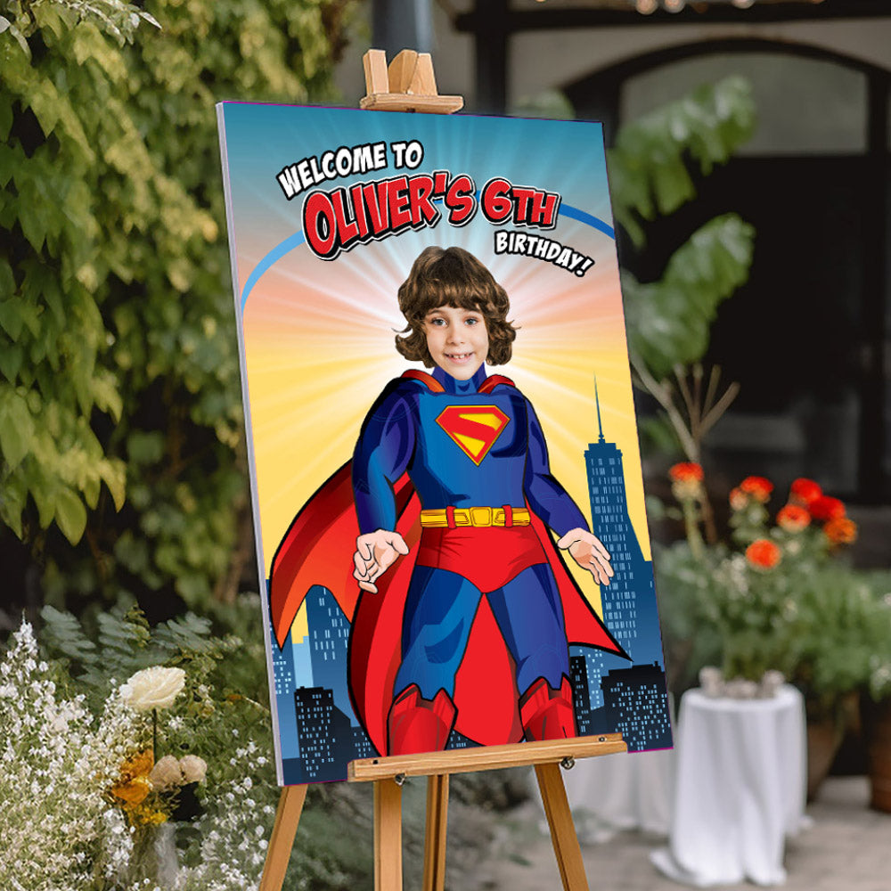 Birthday sign with a child in a Superman costume on an easel outdoors.